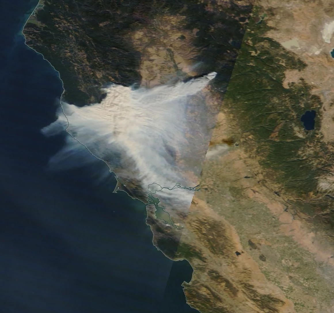 NASA satellite image from November 8, 2018 showing the Camp Fire smoke plume spreading southwest from Butte County across the Sacramento Valley and San Francisco Bay Area