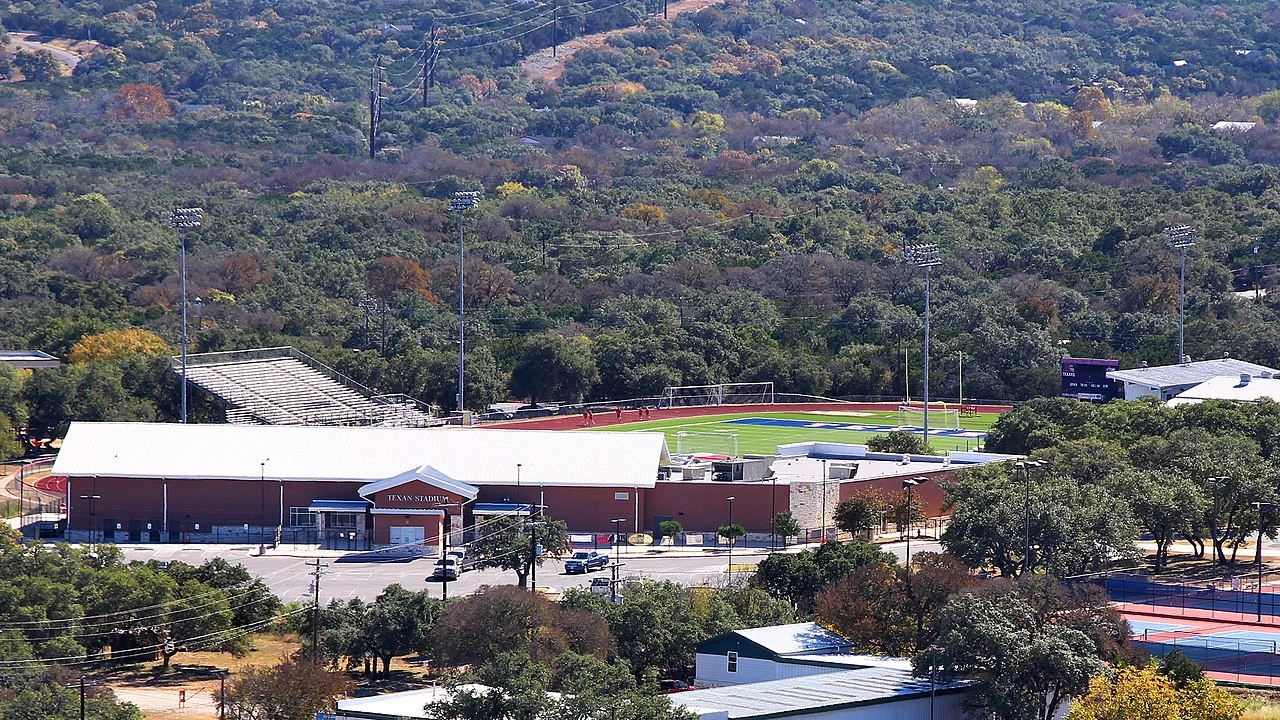 View across Wimberley, Texas, from Old Baldy showing the valley setting and wooded Hill Country slopes around the town