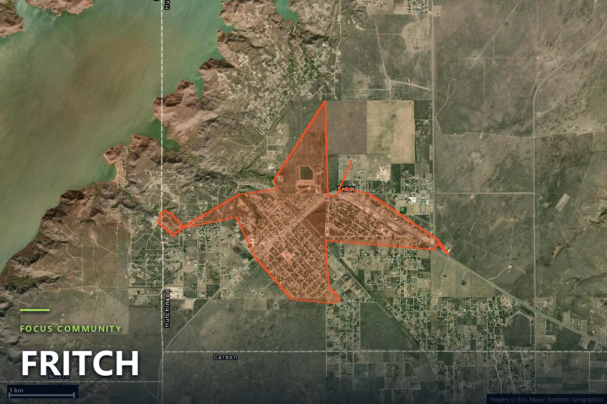 Satellite view of the Fritch town boundary in Hutchinson County, Texas, showing the small street grid surrounded on every side by open prairie and the broken canyon terrain above Lake Meredith