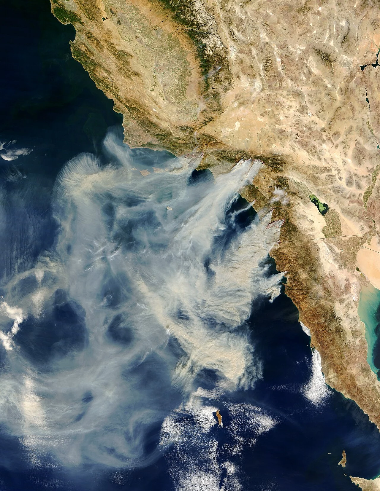 Satellite image from October 2003 showing smoke plumes from the Cedar Fire and other Southern California wildfires streaming southwest over the Pacific Ocean off San Diego