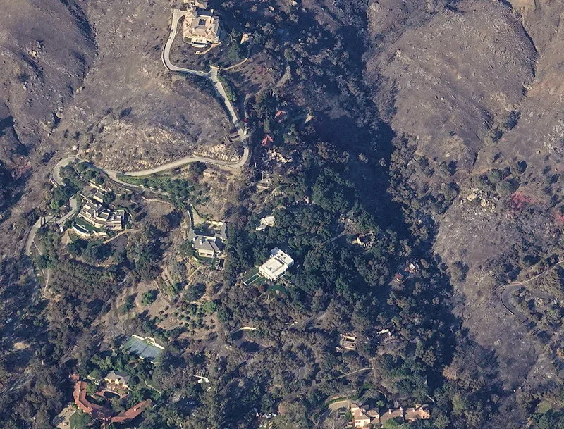 Aerial photo of the Montecito hills near the southwestern edge of the 2017 Thomas Fire, showing large homes standing amid freshly burned slopes where the fire overlapped the 2008 Tea Fire footprint