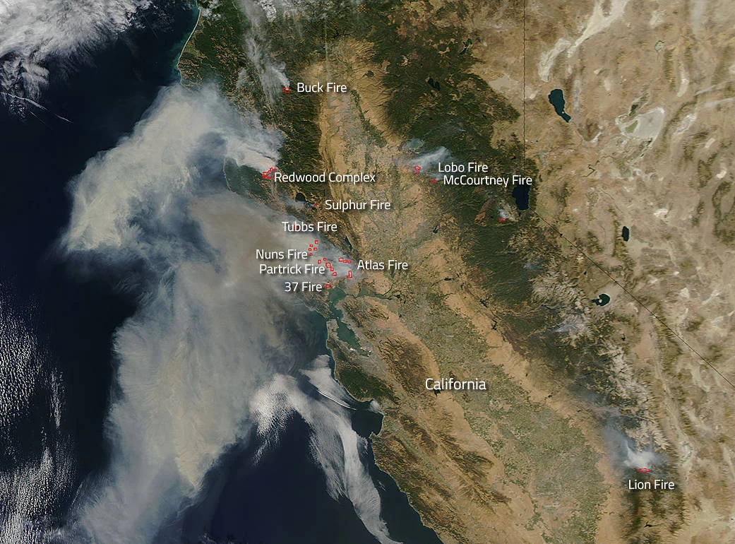 NASA Aqua satellite image from October 2017 showing smoke plumes from the Tubbs, Nuns, Atlas and other Northern California wildfires streaming out over the Pacific Ocean