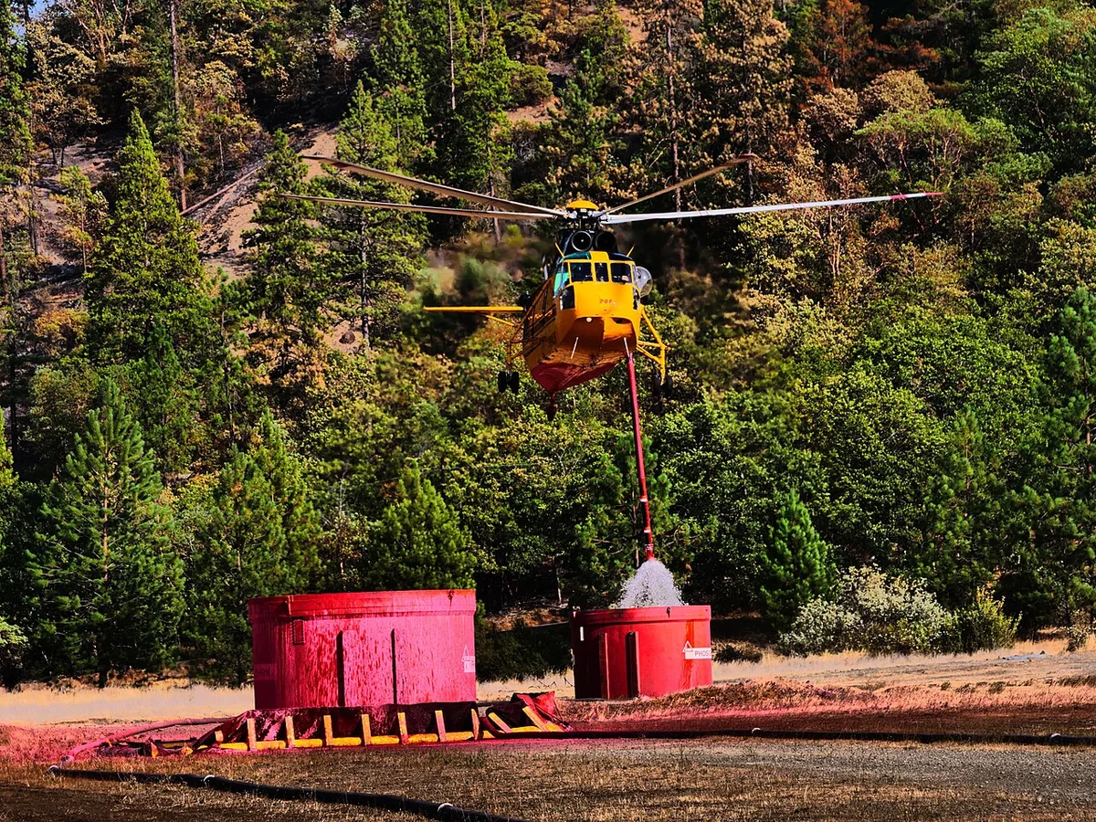 Monument Fire (2021) in Trinity County, California - A heavy lift helicopter lifts off after filling its tank with water on 8-17-21.